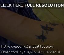 bird flying tattoo forearm