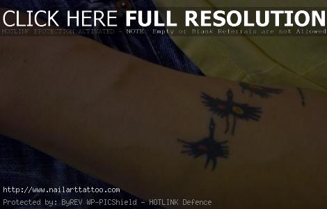 bird flying tattoo forearm