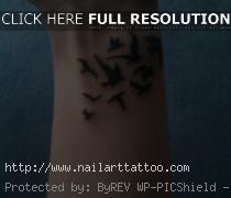 bird flying tattoo on wrist