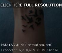 flying bird tattoo on wrist