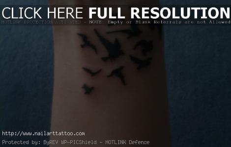 flying bird tattoo on wrist