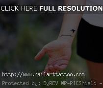 flying bird tattoos on wrist