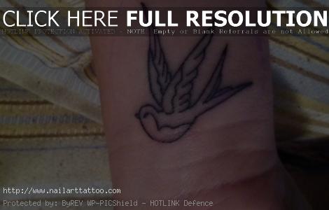 small bird tattoo on wrist