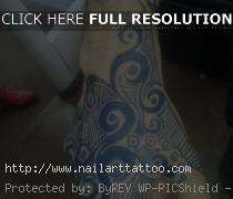 blue ink tattoo on dark skin
