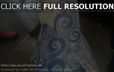 blue ink tattoo on dark skin