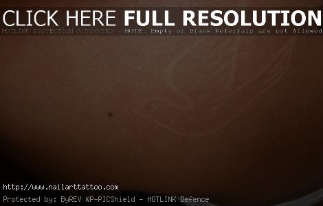 brown ink tattoos on black skin