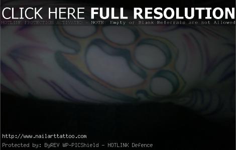 gun and brass knuckles tattoos