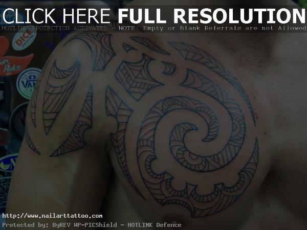 Tribal Shoulder And Chest Tattoo