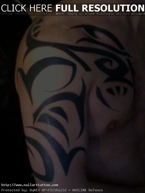 Tribal Shoulder And Chest Tattoo