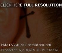 cross tattoo behind ear