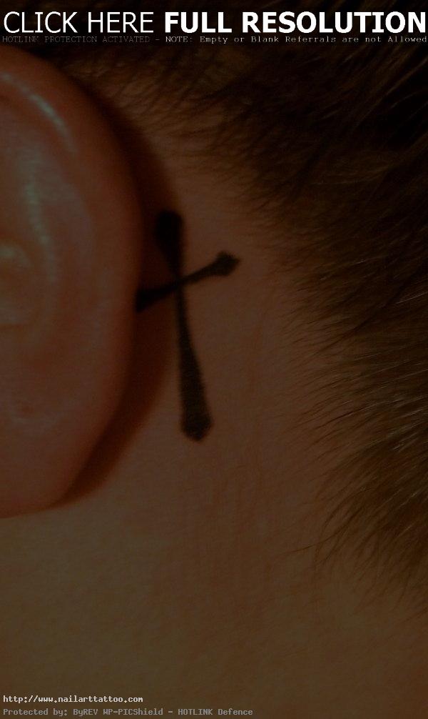 cross tattoo behind ear