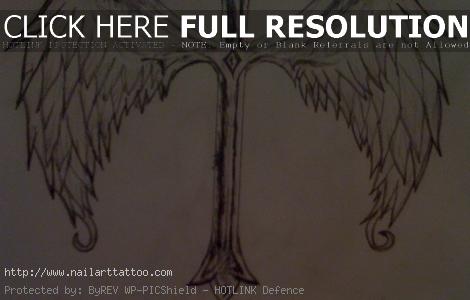 cross tattoo with wings