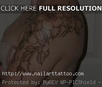 flower outline tattoo on shoulder