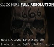 Skull tattoo on hand 666