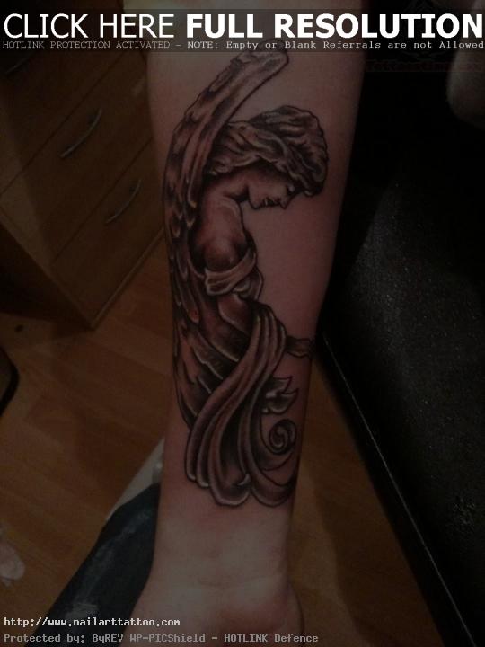 angel tattoo on right forearm